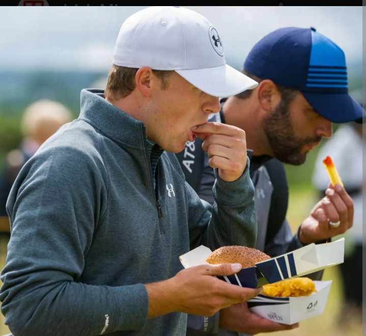 A Bite of Friendship: Jordan and His Buddy Take a Break from the Greens